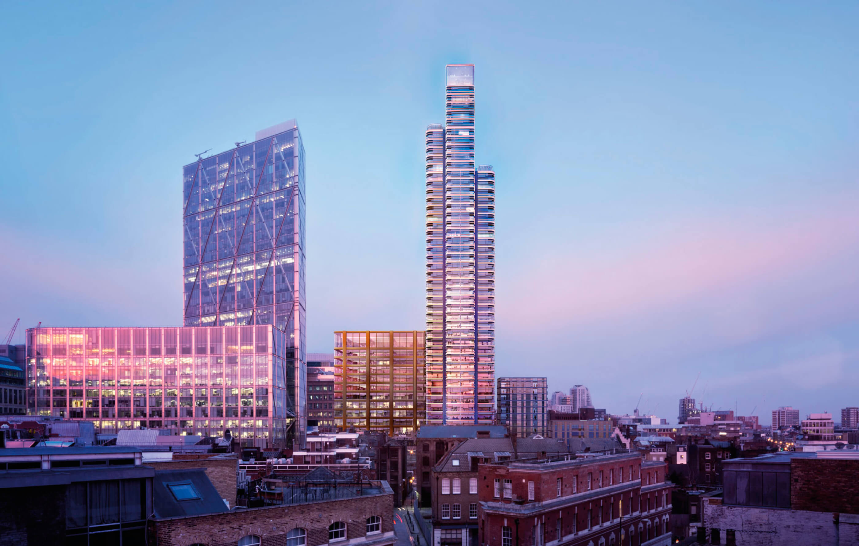 Street level view of Principal Tower in its entirety, glowing pink and purple against the evening sunshine and a blue sky