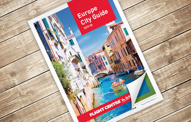 Europe City Guide brochure front cover, featuring a sunny shot of a canal in Venice with boats moared along its sides